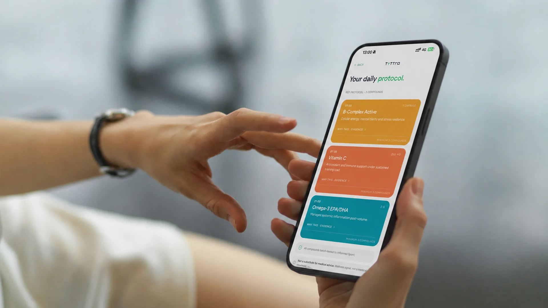 Hands holding a phone with the Tyttra app open on Your daily protocol